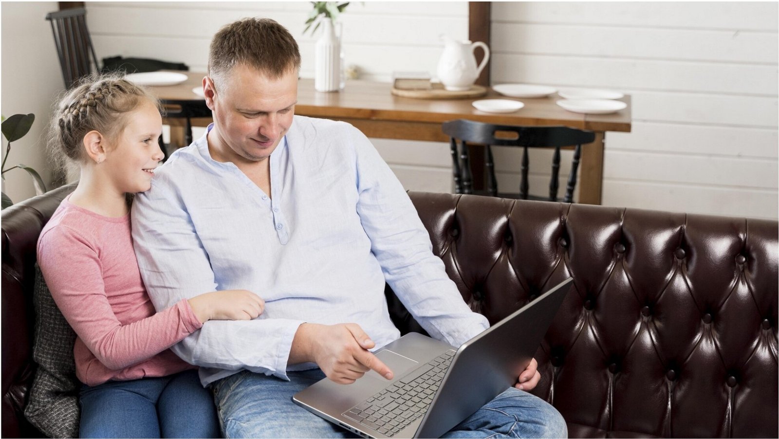 Father and daughter using a laptop